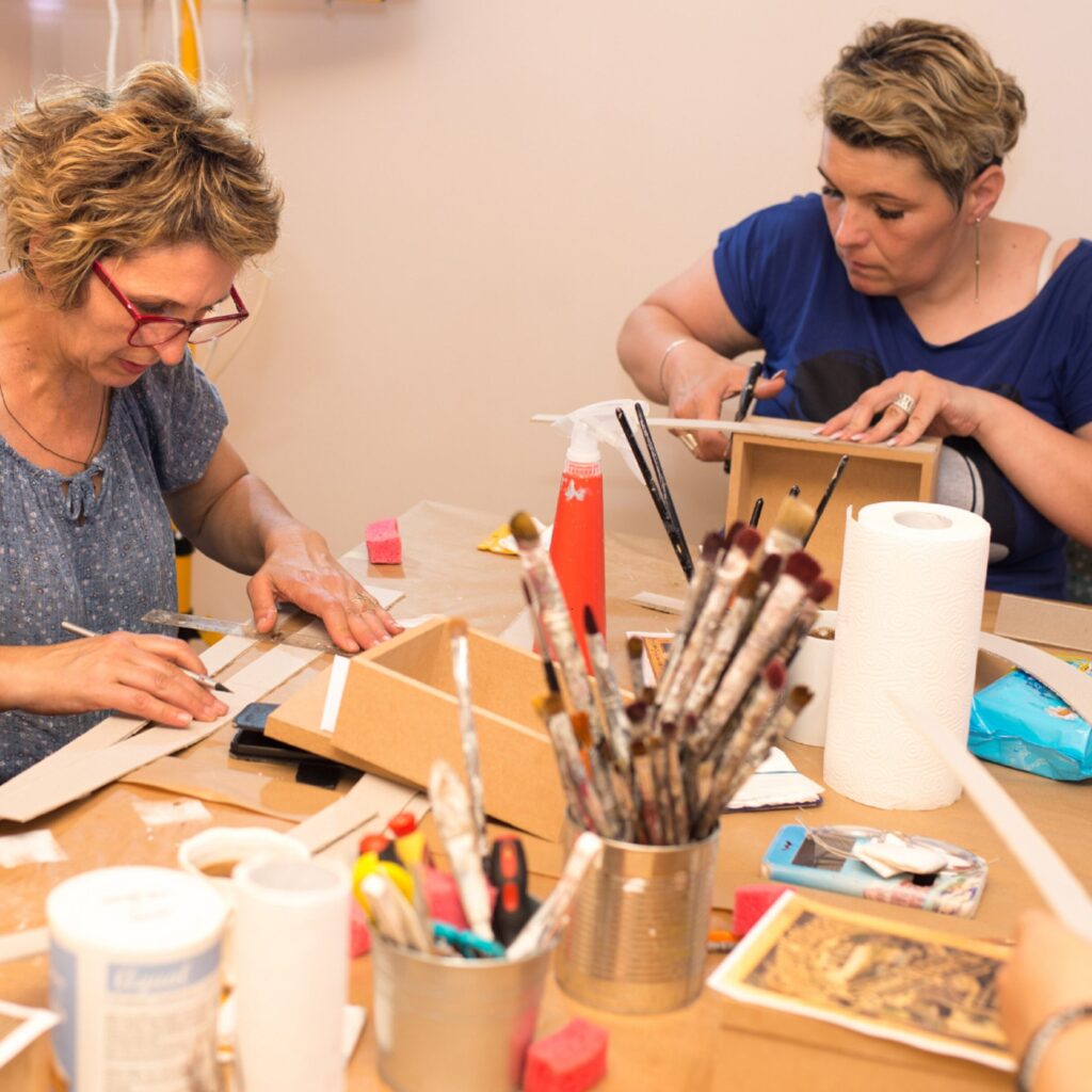 Two women engaged in an arts & craft group
